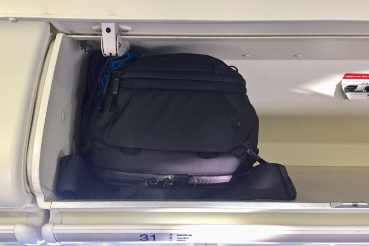 The Travel Backpack inside an overhead compartment of a KLM/Air France Boeing 737-800