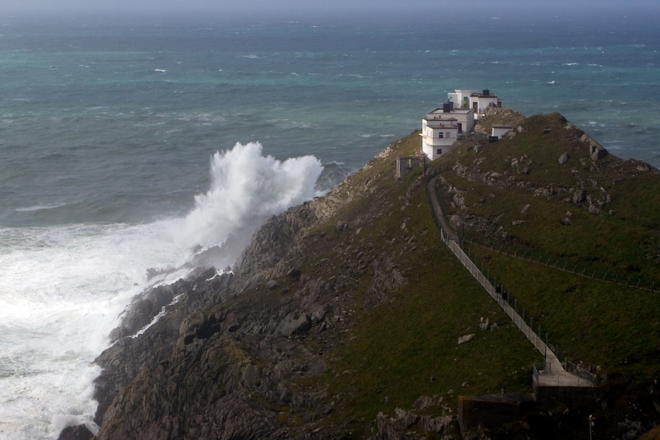 Large swells breaking of the rocks below Mizen Head Signal Station